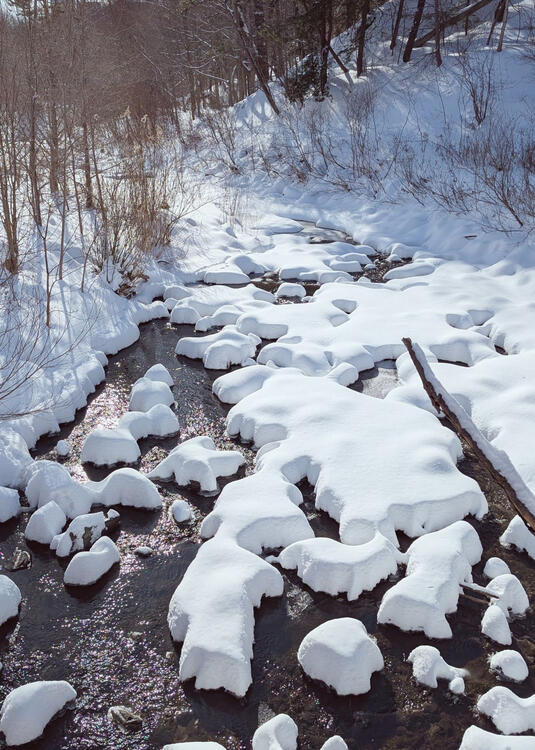 little islands of snow in a creek