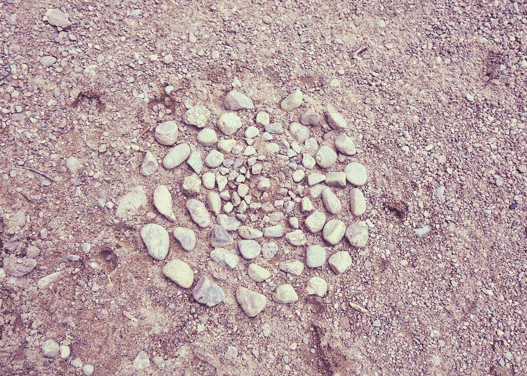 small stones arranged in concentric circles on a gravel beach