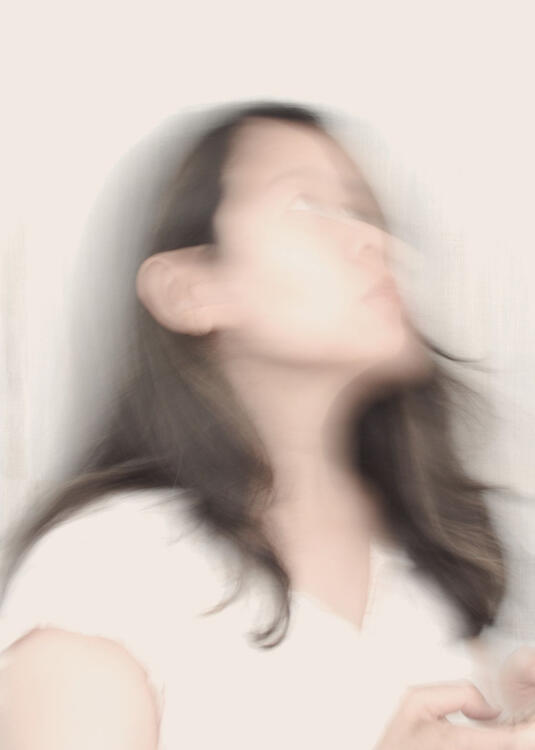blurry photo of a woman staring upwards