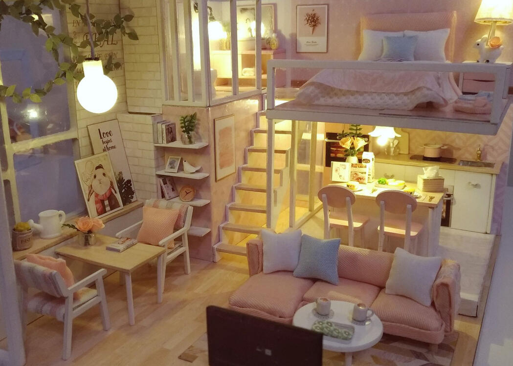 miniature loft-style house made of paper, wood, and fabric, all in pink and white decor and working lights