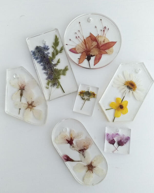 an assortment of pressed-flowers formed in plastic resin shaped ornaments
