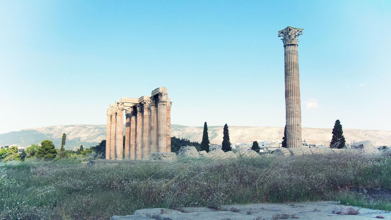 old temple ruin in a field around sunset